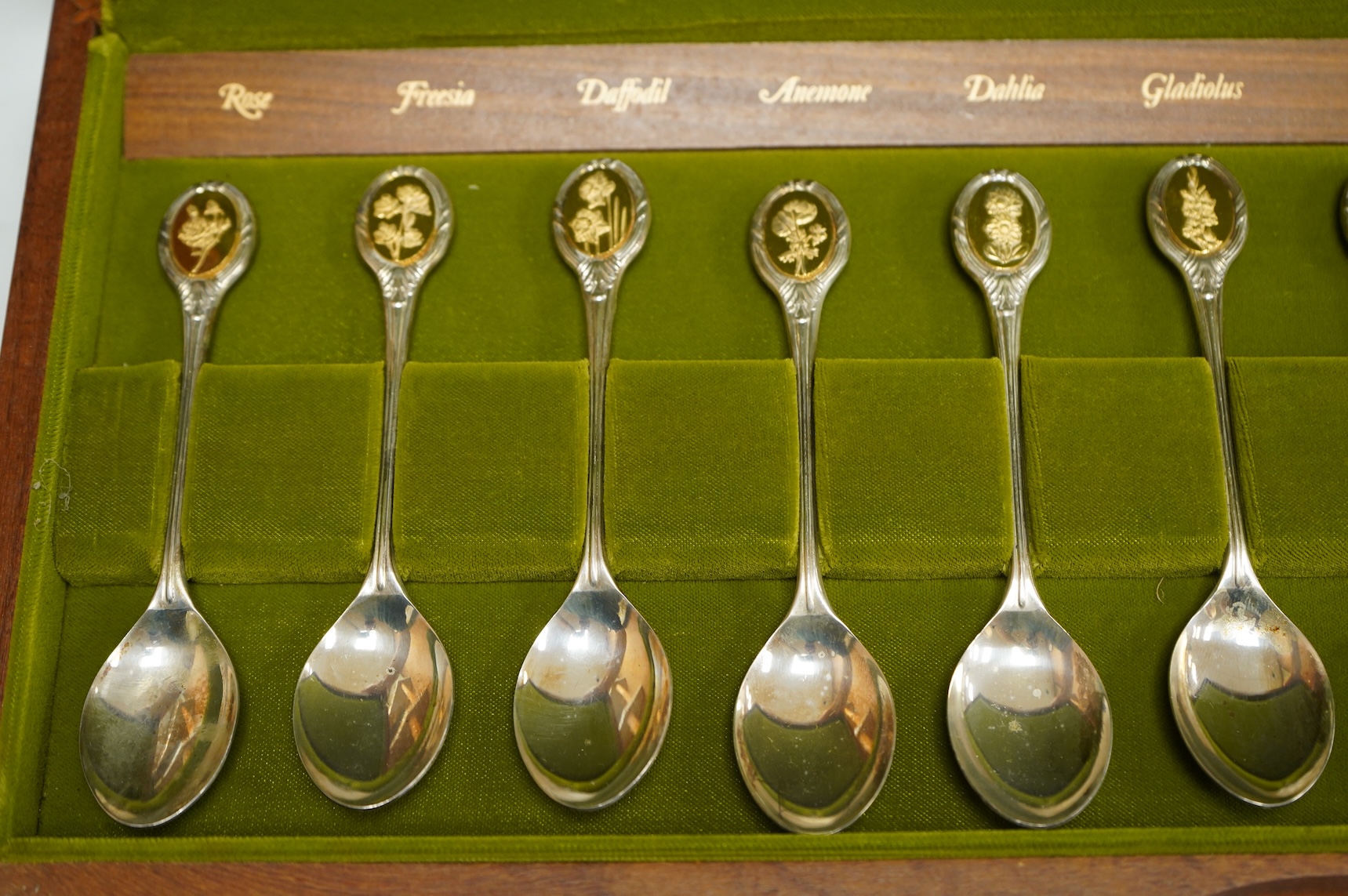 A cased set of twelve Elizabeth II parcel gilt silver Royal Horticultural Society spoons, by John Pinches, Sheffield, 1974.